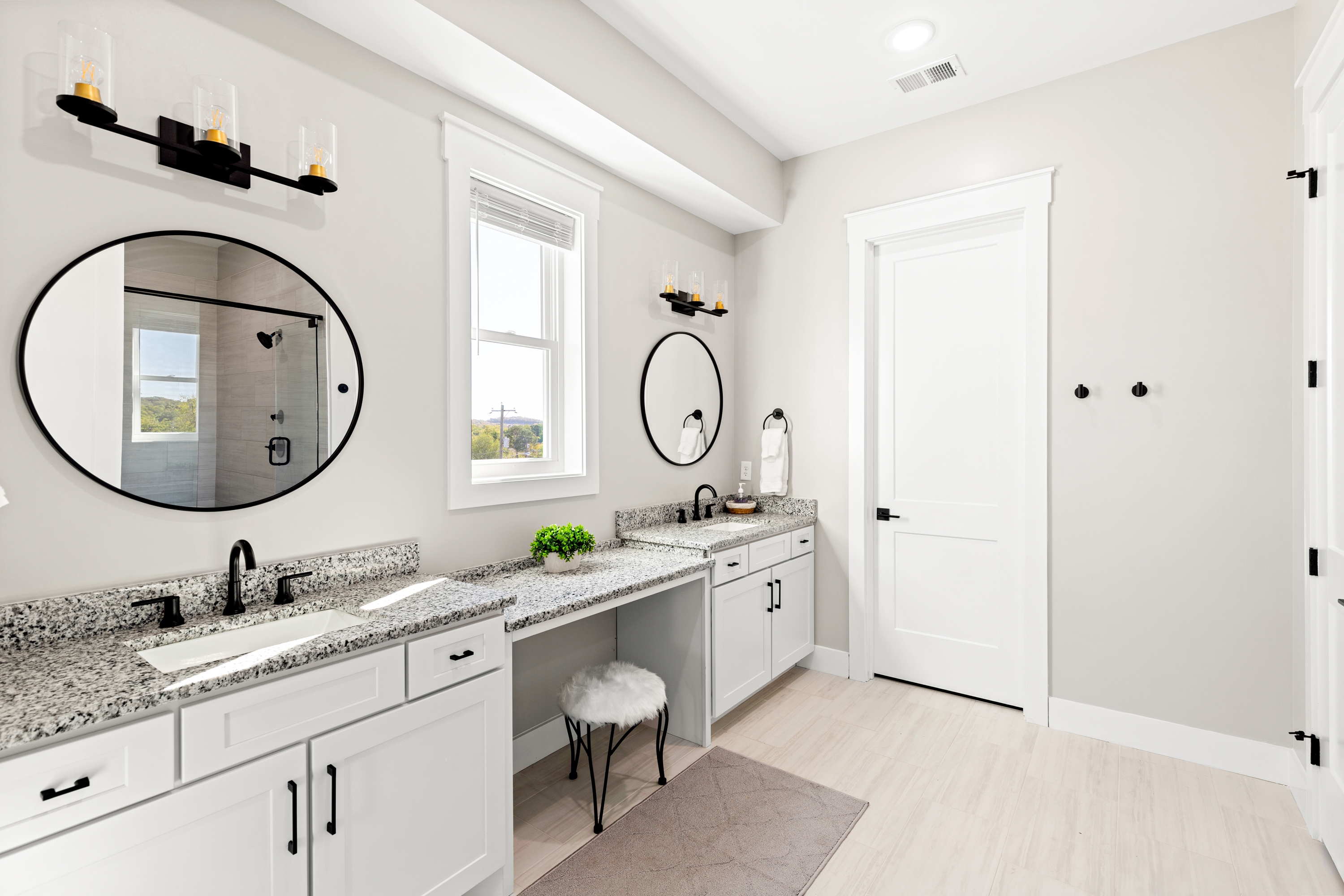 Luxurious bathroom with black fixtures and marble countertops